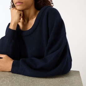 Model wearing Lisa Yang The Doria Cashmere Sweater in navy with scoop neckline, long sleeves, and ribbed trims
