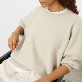 Model wearing Lisa Yang The Hally Cashmere Sweater in Oyster, crew neck, relaxed fit, styled with matching wide-leg trousers