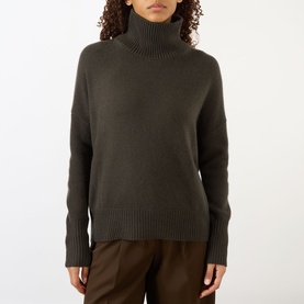 Model wearing Lisa Yang The Heidi Turtleneck Sweater in Dove Grey, 100% cashmere with ribbed trims, dropped shoulders, styled with brown trousers