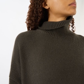 Model wearing Lisa Yang The Heidi Turtleneck Sweater in Dove Grey, close-up showing ribbed turtleneck and dropped shoulder detail in 100% cashmere