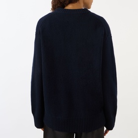 Model wearing Lisa Yang Noor Cashmere Sweater in navy, shown from the back, with ribbed trims and crew neckline.