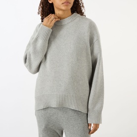 Model wearing Lisa Yang The Noor Knit Sweater in Dove Grey, 100% cashmere with crew neck, dropped shoulders and ribbed trims, styled with matching