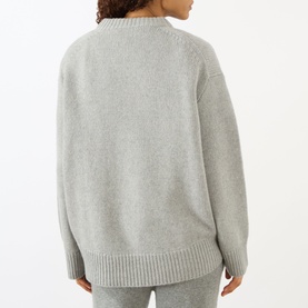 Model wearing Lisa Yang The Noor Knit Sweater in Dove Grey, back view, crew neck, dropped shoulders, ribbed hem, 100% cashmere