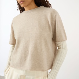 Model wearing Lisa Yang sand cashmere T-shirt with ribbed long-sleeve layer underneath, cropped boxy fit