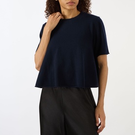 Model wearing Lisa Yang Liru Cashmere T-Shirt in navy, round neck, short sleeves, cropped silhouette, styled with black wide-leg trousers