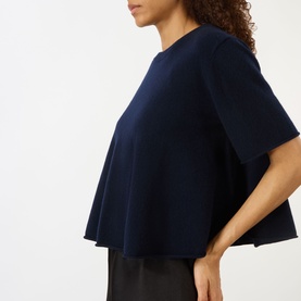 Model wearing Lisa Yang Liru Cashmere T-Shirt in navy, round neck, short sleeves, A-line silhouette, styled with black trousers.
