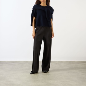 Model wearing Lisa Yang Liru Cashmere T-Shirt in navy with wide-leg dark trousers and black pointed-toe shoes.