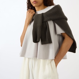 Model wearing Lisa Yang Liru Cashmere T-Shirt in Seashell, styled with a dark grey knit scarf and cream wide-leg trousers.