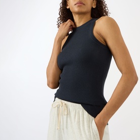 Model wearing Lisa Yang Amya Rib Tank Top in navy, ribbed sleeveless style with round neck, styled with cream drawstring trousers