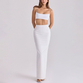 Model wearing House of CB white cut-out maxi skirt co-ord set with spaghetti strap crop top and column skirt