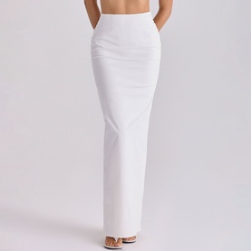 Model wearing House of CB white maxi skirt, rear view, styled with strappy heeled sandals