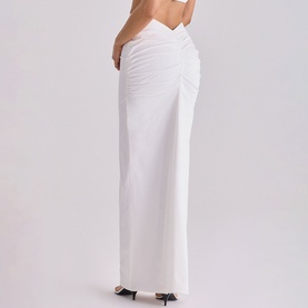 Model wearing House of CB white maxi skirt with ruched waist detail, shown from behind, paired with black heels