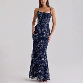 Model wearing navy blue floral embroidered sleeveless maxi dress with square neckline, thin straps, and fitted mermaid silhouette