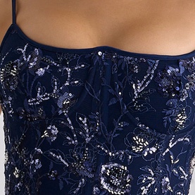 Model wearing navy blue strappy camisole top with allover floral sequin and beaded embellishment