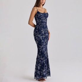 Model wearing navy blue floral sequin maxi dress with thin spaghetti straps, fitted bodice and fishtail hem
