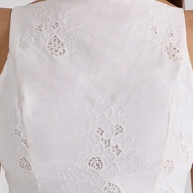 House of CB white broderie anglaise top, close-up showing floral cutwork embroidery detail on structured bodice fabric.