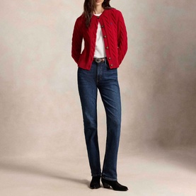 Model wearing Polo Ralph Lauren red cable-knit cardigan with gold buttons, styled with white top, dark blue jeans and black ankle boots.