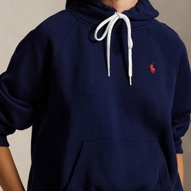 Model wearing Polo Ralph Lauren Cruise Navy hoodie, white drawstring, red embroidered pony logo, kangaroo pocket visible