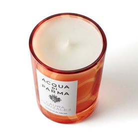 Acqua Di Parma scented candle in amber red glass vessel with white label, single wick, smooth wax surface visible from above.