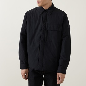Model wearing Calvin Klein Jeans Back Graphic Padded Overshirt in black, point collar, front zip, logo badge on sleeve, styled with dark jeans