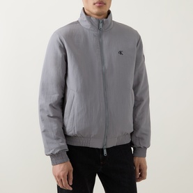 Model wearing Calvin Klein Jeans Harrington Logo Weatherproof Jacket in Convoy grey, with stand collar, zip fastening and monogram logo. Styled with