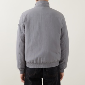 Model wearing Calvin Klein Jeans Harrington Logo Weatherproof Jacket in Convoy grey, back view, styled with dark jeans