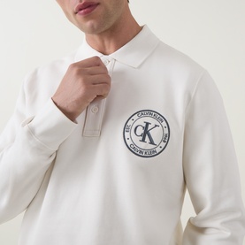 Model wearing Calvin Klein Jeans Tofu sweatshirt with polo collar and navy circular logo graphic on chest.