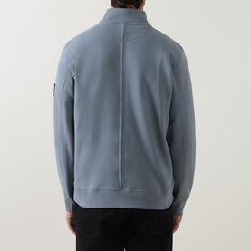 Model wearing Calvin Klein Jeans Steel Gray quarter-zip sweatshirt, rear view showing back seam detail and sleeve badge logo.