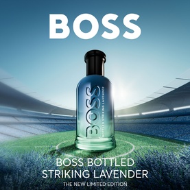 Hugo Boss Bottled Striking Lavender limited edition EDP in gradient blue-green glass bottle, displayed against a stadium backdrop.