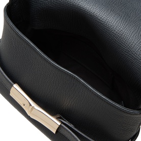 Longchamp black crossbody bag, overhead view showing textured cowhide leather exterior and gold-tone clasp hardware detail.