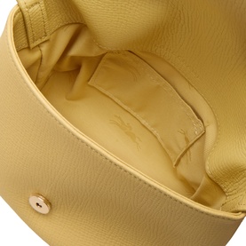 Longchamp Foin crossbody bag interior view showing yellow leather lining, single compartment, and gold-tone stud detail