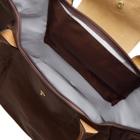 Longchamp Moka shoulder bag interior view showing grey lining, open main compartment and gold hardware detail