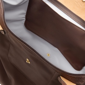 Longchamp Moka shoulder bag interior view showing grey fabric lining, zip pocket, and gold-tone press stud detail