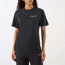 Model wearing Sporty and Rich Signature NY Logo T-Shirt in Faded Black, round neck, short sleeves, styled with matching joggers