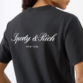 Model wearing Sporty and Rich Signature NY Logo T-Shirt in Faded Black, back view showing cursive New York logo print.