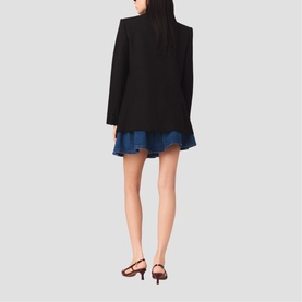Model wearing Maje Womens French Dress in red, shown from behind, styled with a black blazer and brown heeled sandals
