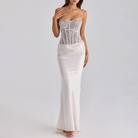 Model wearing House of CB white strapless maxi dress with lace corset bodice and satin skirt, fitted silhouette