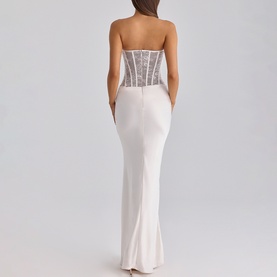 Model wearing House of CB white strapless maxi dress with sheer lace corset bodice and sleek fitted skirt, back view