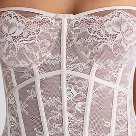 House of CB white lace corset top, close-up detail showing floral lace overlay, boning panels and scalloped trim neckline