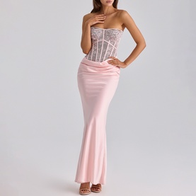 Model wearing House of CB pink strapless maxi dress with lace corset bodice and satin mermaid skirt, styled with strappy heels