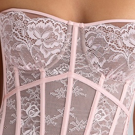House of CB pink lace corset with structured boning panels and floral lace detailing, close-up view