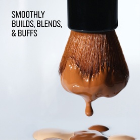 Bobbi Brown brush with liquid foundation dripping from bristles, demonstrating blending and buffing capability