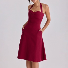 Model wearing House of CB wine halterneck midi dress with sweetheart neckline, A-line skirt and side pockets