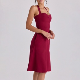 Model wearing House of CB wine halterneck midi dress with sweetheart neckline and A-line skirt silhouette