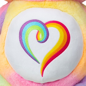 Care Bears rainbow pastel plush close-up showing embroidered multicolour heart belly badge detail