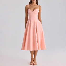 Model wearing House of CB peach midi dress with sweetheart neckline, spaghetti straps and full A-line skirt, styled with strappy heels