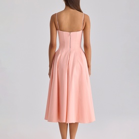 Model wearing House of CB peach midi dress with spaghetti straps, fitted bodice and full A-line skirt, shown from the back