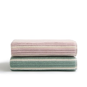 Christys bath towels in multi, stacked pair showing ribbed texture in pink and sage green colourways