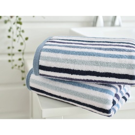 Deyongs Linear Stripe Towel Blue, folded stack of two towels with blue, navy and white horizontal stripes, in a bathroom setting.