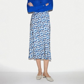 Model wearing Jigsaw blue and white leopard-print midi skirt, styled with a blue jumper and cream flat mules.